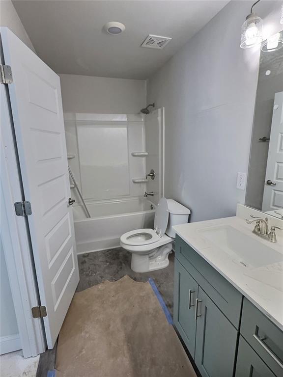 full bathroom featuring vanity, shower / bath combination, and toilet