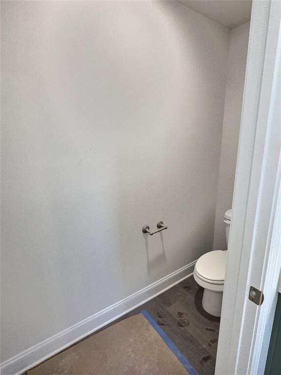 bathroom with wood-type flooring and toilet