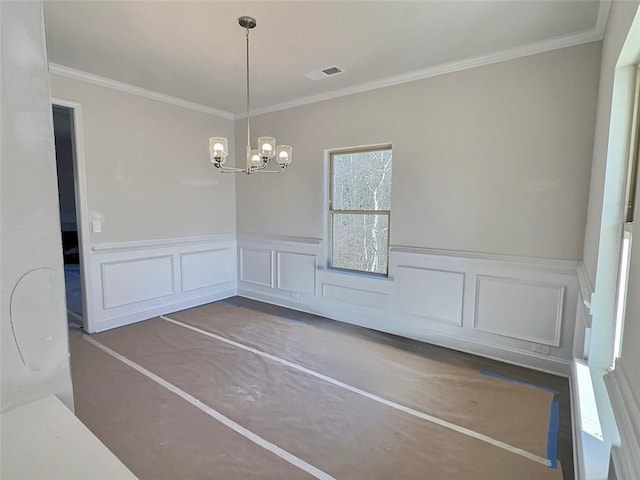 unfurnished dining area with crown molding and a chandelier