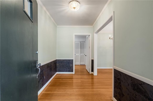 hall with hardwood / wood-style flooring and ornamental molding