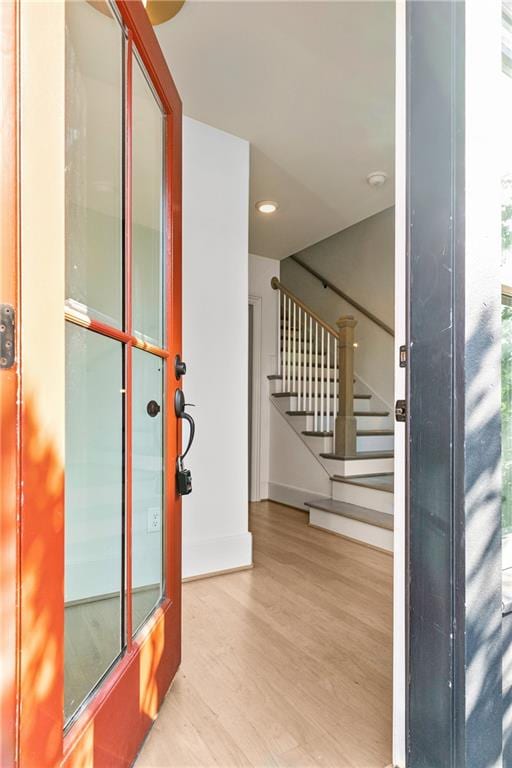 foyer featuring light wood-type flooring and a wealth of natural light