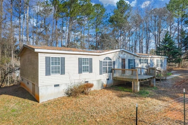 view of front of home featuring crawl space, a front yard, and a wooden deck