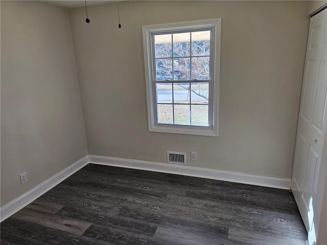 spare room with dark hardwood / wood-style floors