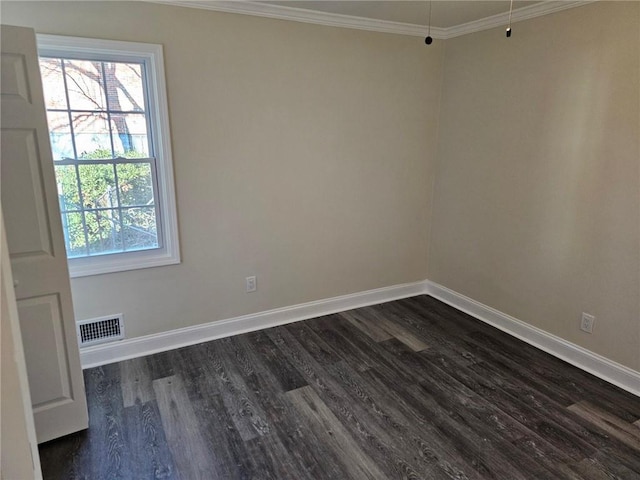 spare room featuring crown molding and dark wood-type flooring