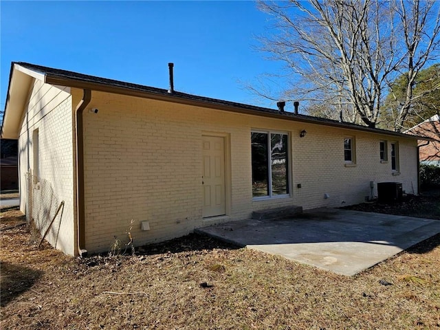 rear view of house featuring cooling unit and a patio area