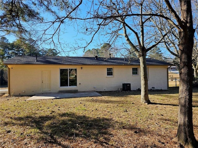 rear view of property with a patio area, a yard, and cooling unit