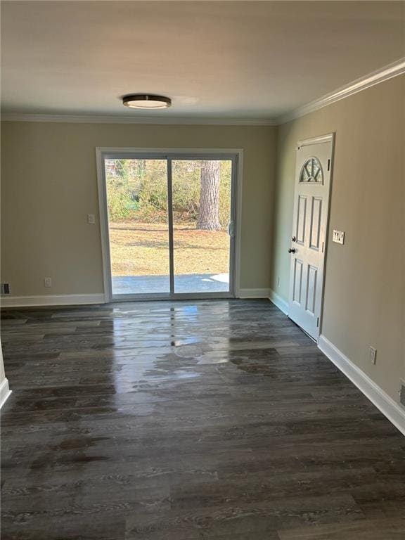 empty room with crown molding and dark hardwood / wood-style floors