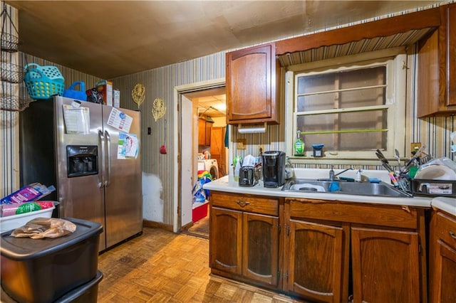 379 Utoy Cir SW, Atlanta, GA 30331 - kitchen with stainless steel fridge with ice dispenser, wallpapered walls, light countertops, and brown cabinetry