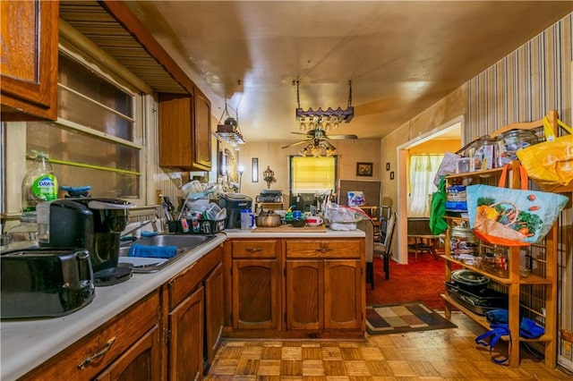 379 Utoy Cir SW, Atlanta, GA 30331 - kitchen with light countertops, brown cabinetry, and a peninsula