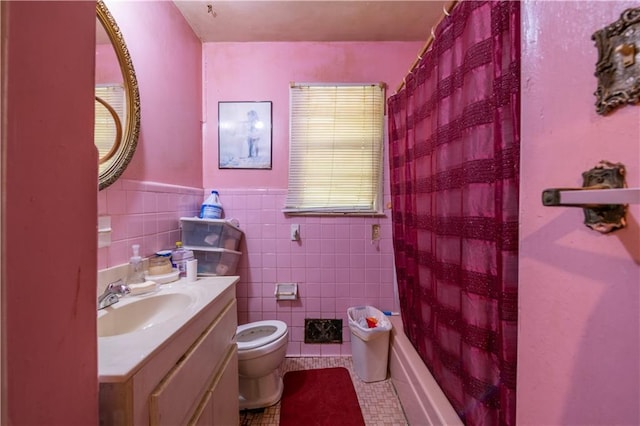 379 Utoy Cir SW, Atlanta, GA 30331 - bathroom with vanity, tile patterned floors, tile walls, a wainscoted wall, and shower / tub combo