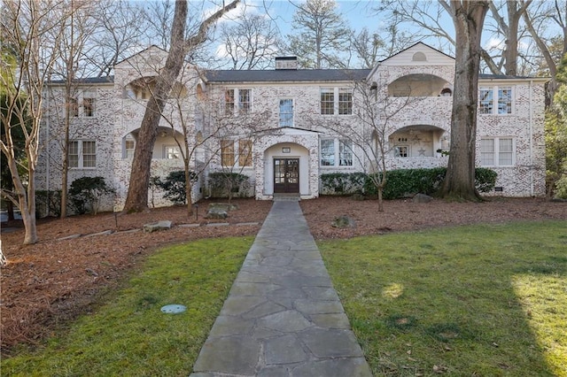 view of front of property with french doors and a front yard