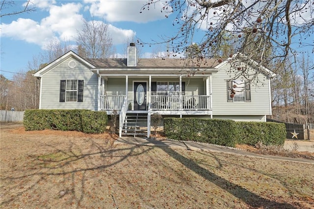 ranch-style home featuring a porch and a front yard