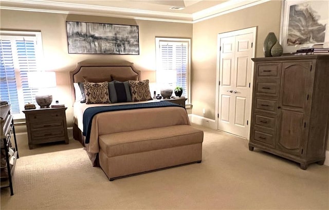 bedroom with crown molding, visible vents, baseboards, and light carpet