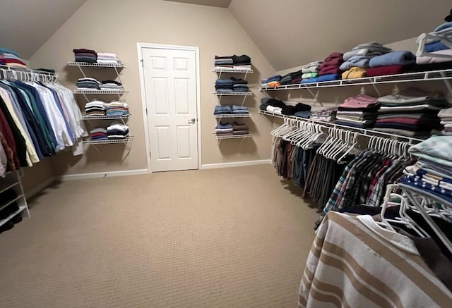 spacious closet featuring vaulted ceiling and carpet