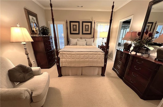 bedroom with ornamental molding, visible vents, and light carpet