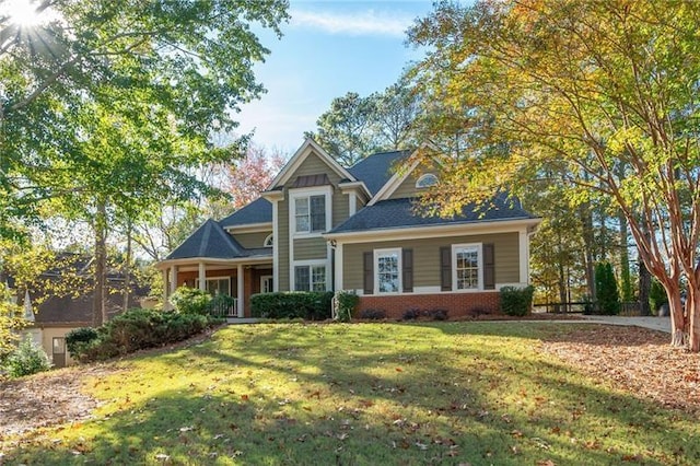 view of front facade with a front yard and brick siding