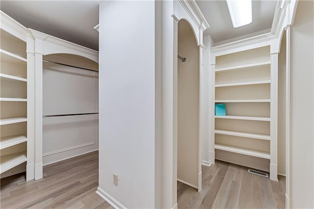 spacious closet featuring visible vents and wood finished floors