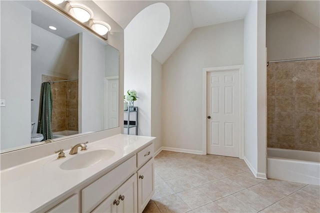 bathroom featuring tile patterned flooring, vaulted ceiling, vanity, and shower / tub combo with curtain