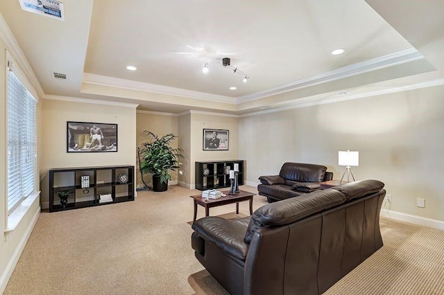 carpeted living area featuring a tray ceiling, crown molding, baseboards, and visible vents