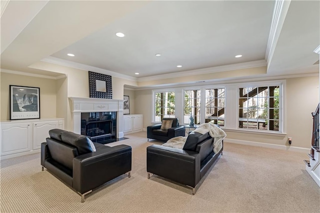 living room with light carpet, a tray ceiling, a high end fireplace, recessed lighting, and baseboards