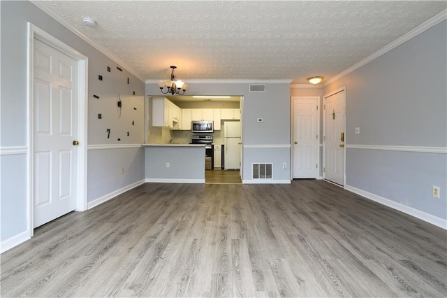 unfurnished living room featuring ornamental molding, a chandelier, a textured ceiling, and light wood-type flooring