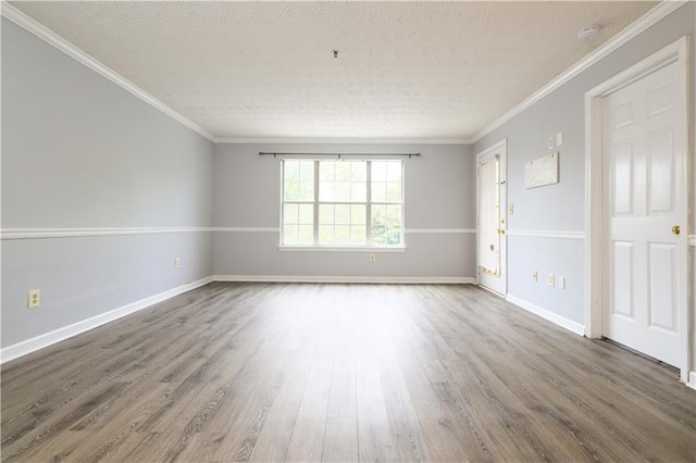 spare room with crown molding, hardwood / wood-style flooring, and a textured ceiling