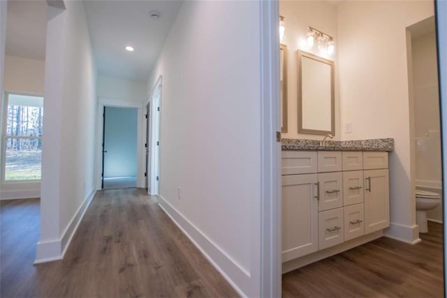 corridor featuring dark hardwood / wood-style floors and sink