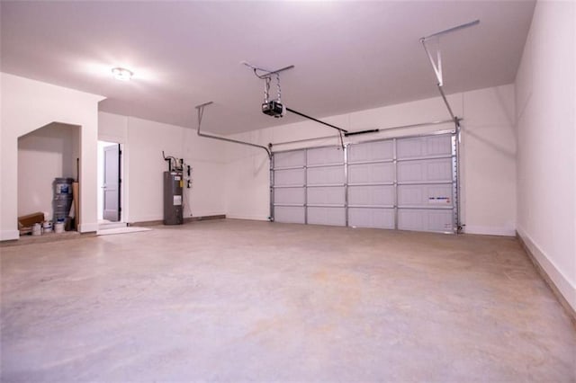 garage featuring water heater and a garage door opener