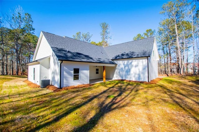 view of front of property featuring a front lawn and central air condition unit