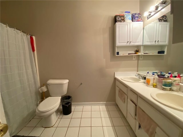 bathroom featuring toilet, tile patterned floors, vanity, and curtained shower