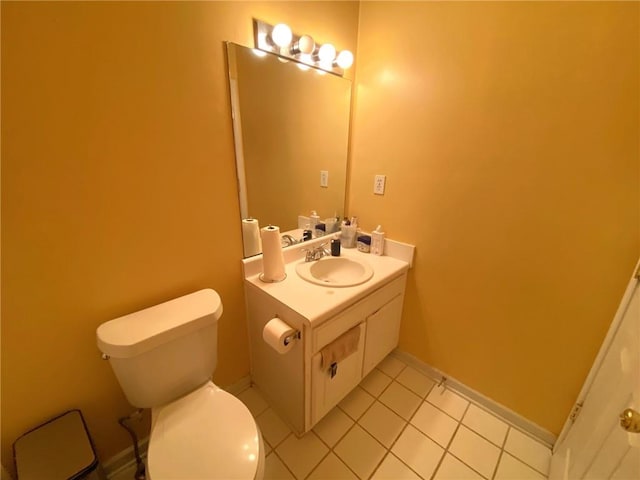 bathroom with toilet, tile patterned floors, and vanity