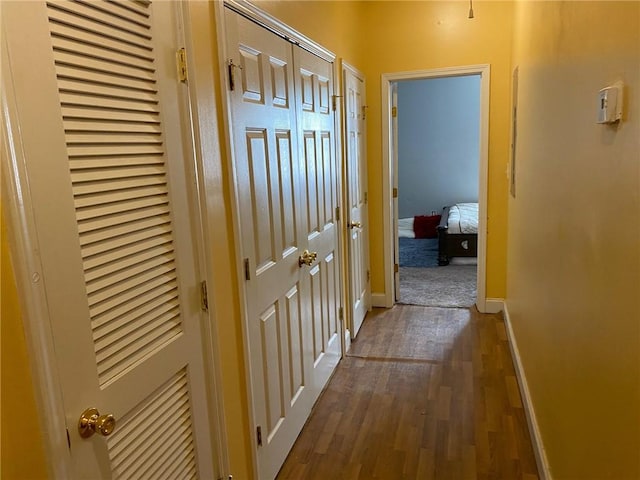 corridor featuring dark wood-type flooring