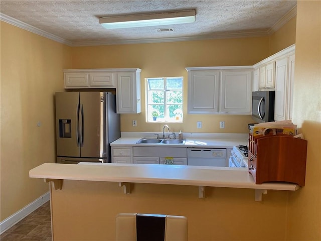 kitchen with sink, white cabinets, and a breakfast bar area