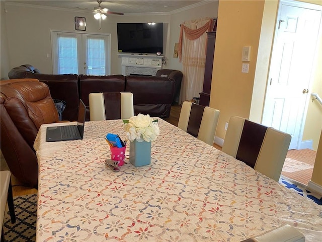 dining area with ceiling fan, crown molding, and french doors