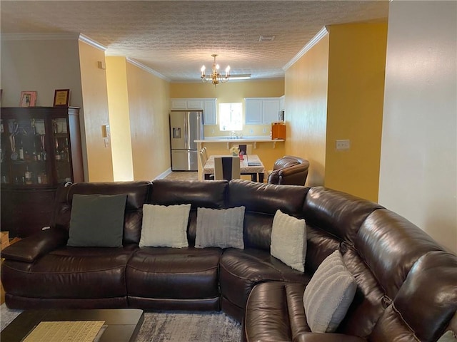 living room featuring crown molding and an inviting chandelier