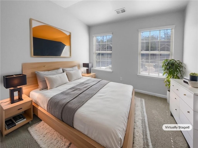 bedroom featuring carpet, multiple windows, visible vents, and baseboards