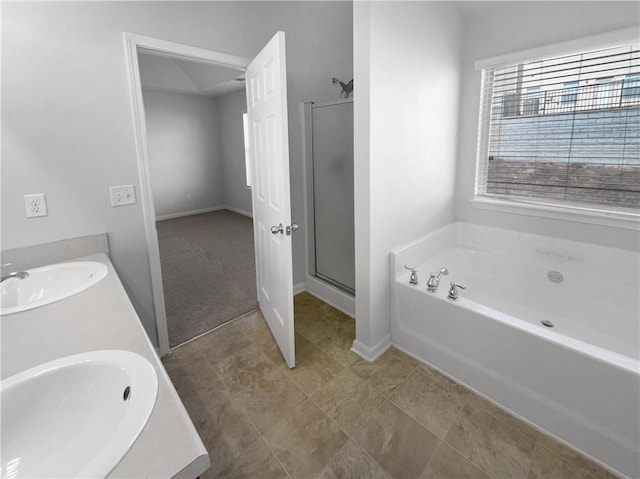 bathroom featuring a stall shower, a sink, a bath, and double vanity