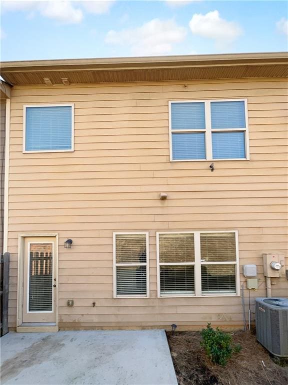 back of property featuring central AC, a patio, and fence