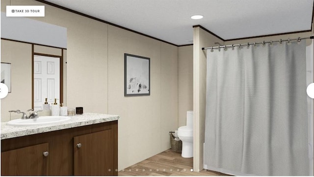 564 Ridge Rd, Dawsonville, GA 30534 - bathroom featuring wood finished floors, toilet, ornamental molding, vanity, and curtained shower