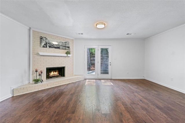 706 Twin Brooks Ct SE, Marietta, GA 30067 - unfurnished living room featuring a textured ceiling, wood finished floors, ornamental molding, and visible vents