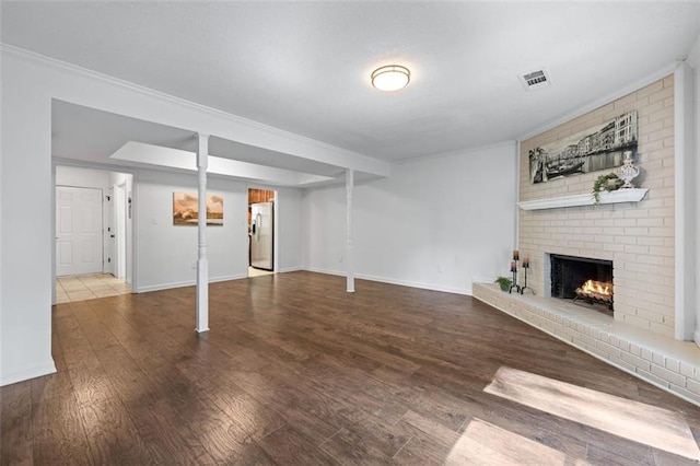 706 Twin Brooks Ct SE, Marietta, GA 30067 - basement with baseboards, stainless steel fridge, a brick fireplace, visible vents, and wood finished floors