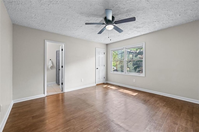 706 Twin Brooks Ct SE, Marietta, GA 30067 - unfurnished bedroom with a closet, baseboards, a ceiling fan, a textured ceiling, and wood finished floors
