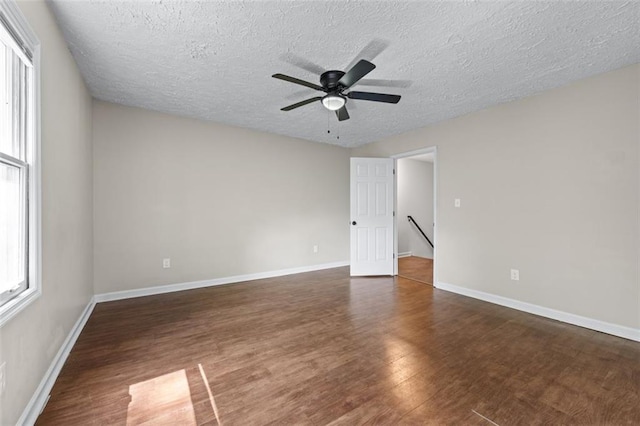 706 Twin Brooks Ct SE, Marietta, GA 30067 - empty room with a textured ceiling, wood finished floors, ceiling fan, and baseboards