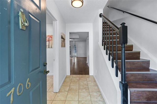 706 Twin Brooks Ct SE, Marietta, GA 30067 - entryway featuring light tile patterned floors, baseboards, and stairway