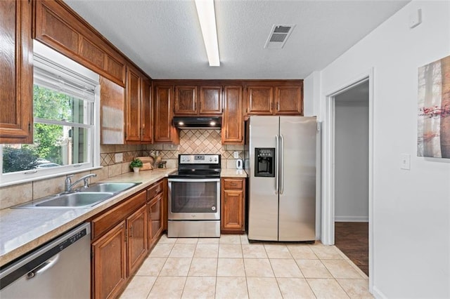 706 Twin Brooks Ct SE, Marietta, GA 30067 - kitchen featuring visible vents, appliances with stainless steel finishes, under cabinet range hood, a sink, and decorative backsplash
