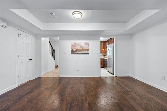 706 Twin Brooks Ct SE, Marietta, GA 30067 - below grade area with baseboards, stainless steel fridge, stairway, visible vents, and wood finished floors
