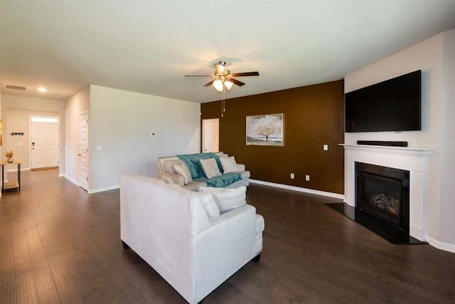 living area featuring a ceiling fan, dark wood-style floors, baseboards, a fireplace, and recessed lighting