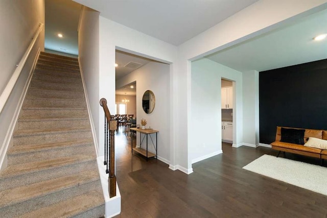 stairs featuring wood finished floors and baseboards