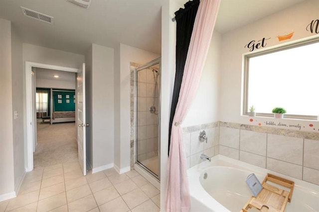ensuite bathroom featuring a shower stall, tile patterned floors, a bath, and baseboards