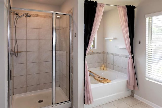 bathroom with a stall shower, tile patterned floors, and a garden tub